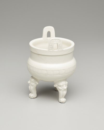 China%2C%20Fujian%20province%2C%20Dehua%20kilns%2C%20%3Cb%3E%3Ci%3E%20Incense%20Burner%20in%20the%20Shape%20of%20an%20Archaic%20Tripod%3C%2Fi%3E%3C%2Fb%3E%2C%2019th%20century%2C%20porcelain%20with%20clear%20glaze%3B%20stamped%20character%20for%20shou%20%28longevity%29%20in%20a%20repeating%20band%20around%20waist%3B%20lion%27s%20head-and-paw%20feet%2C%20Gift%20of%20an%20Anonymous%20Donor%2C%20public%20domain%2C%202002.67.3